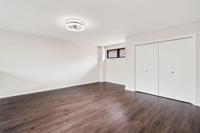 434 11th St Unit D, New Richmond, WI 54017 - unfurnished bedroom featuring dark wood-style floors and a closet