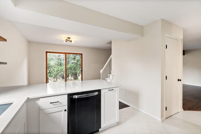 434 11th St Unit D, New Richmond, WI 54017 - kitchen featuring black dishwasher, white cabinets, a peninsula, and light tile patterned flooring