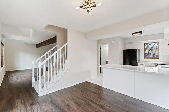 434 11th St Unit D, New Richmond, WI 54017 - unfurnished living room with stairs, dark wood-type flooring, and a chandelier