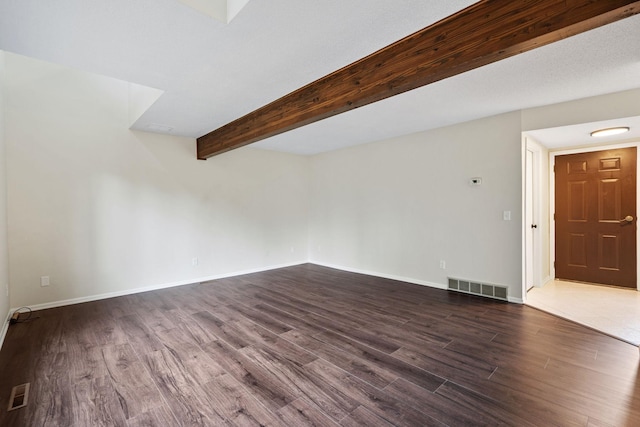 434 11th St Unit D, New Richmond, WI 54017 - unfurnished living room featuring dark wood-type flooring and beamed ceiling