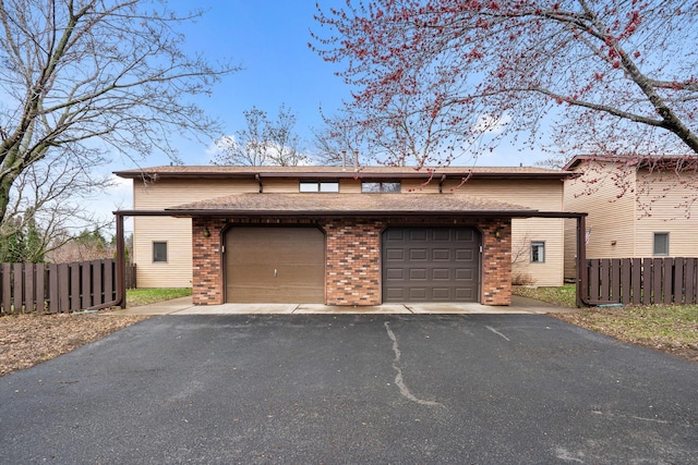 434 11th St Unit D, New Richmond, WI 54017 - view of front of property with driveway, a garage, and brick siding