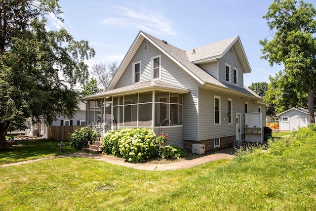 311 Fremont St, River Falls, WI 54022 - back of property with a sunroom and roof with shingles