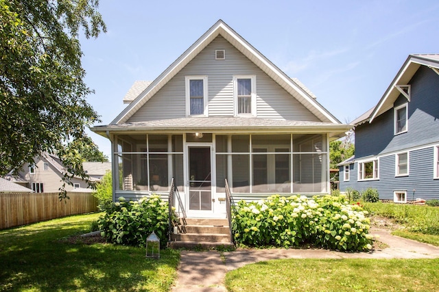311 Fremont St, River Falls, WI 54022 - view of front of house with a sunroom and a shingled roof