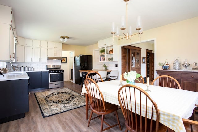 311 Fremont St, River Falls, WI 54022 - dining room with wood finished floors and a chandelier