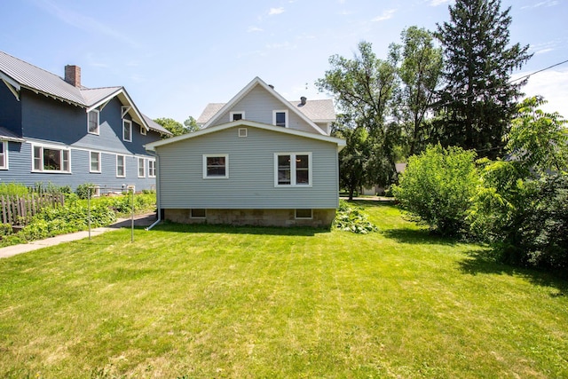 311 Fremont St, River Falls, WI 54022 - rear view of property featuring a yard