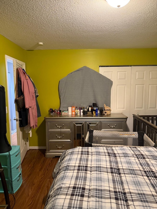 8208 Halifax Ct N, Brooklyn Park, MN 55443 - bedroom featuring dark wood finished floors, a textured ceiling, and a closet