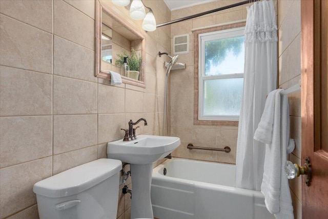3506 Boardman St, Minneapolis, MN 55417 - bathroom featuring tile walls and shower / bathtub combination with curtain
