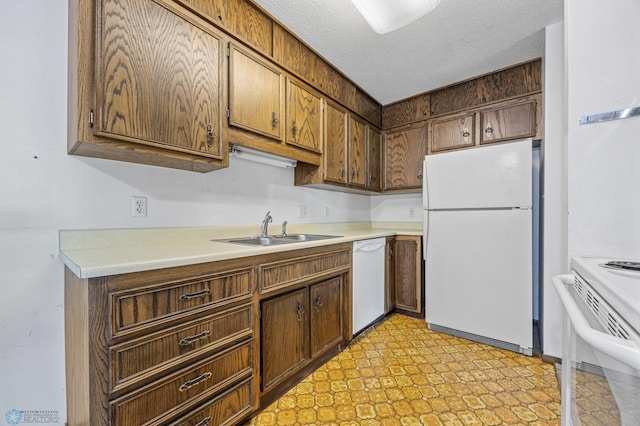 812 10th St S Unit B12, Fargo, ND 58103 - kitchen featuring white appliances, light countertops, light flooring, and a textured ceiling