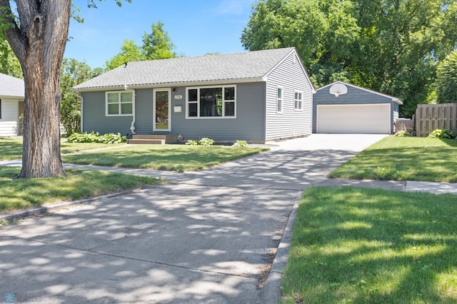 1706 14 1/2 St S, Fargo, ND 58103 - single story home featuring an outdoor structure, a detached garage, and a front yard