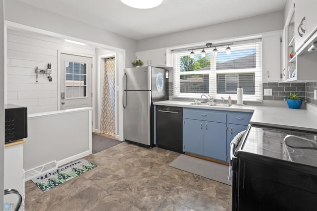 1706 14 1/2 St S, Fargo, ND 58103 - kitchen with black appliances, blue cabinets, light countertops, and decorative backsplash
