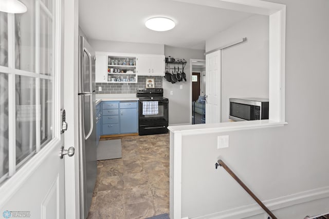 1706 14 1/2 St S, Fargo, ND 58103 - kitchen featuring stainless steel appliances, open shelves, blue cabinetry, tasteful backsplash, and stone finish floors