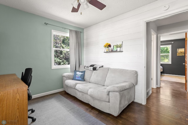 1706 14 1/2 St S, Fargo, ND 58103 - office area with healthy amount of natural light, a ceiling fan, dark wood finished floors, wooden walls, and a textured ceiling