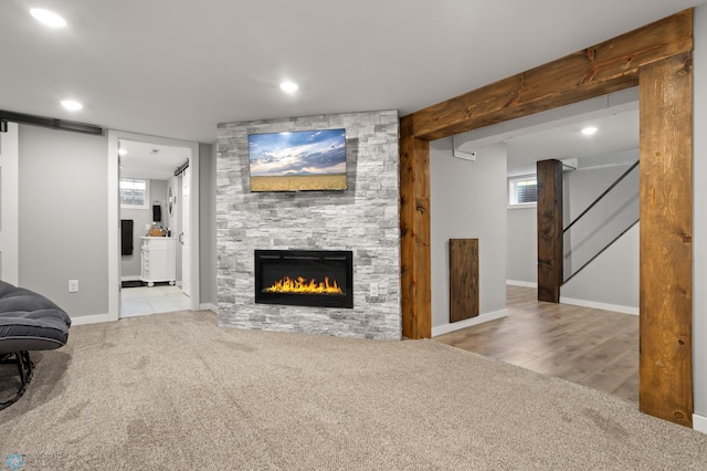 1706 14 1/2 St S, Fargo, ND 58103 - unfurnished living room with carpet floors, a stone fireplace, and recessed lighting