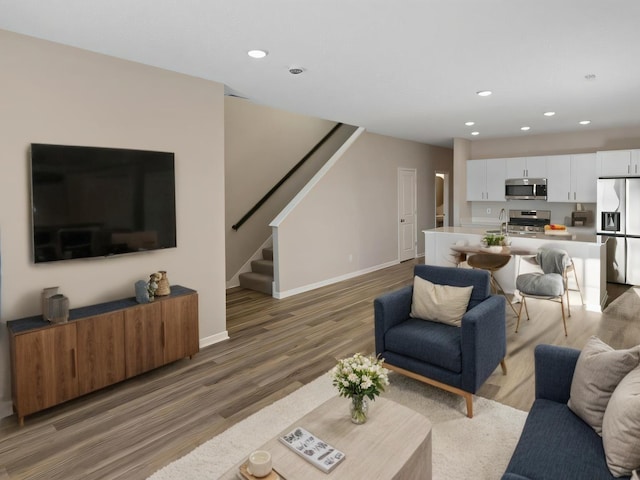 7861 Ramsey Pkwy NW, Ramsey, MN 55303 - living area with stairs, light wood-type flooring, and recessed lighting