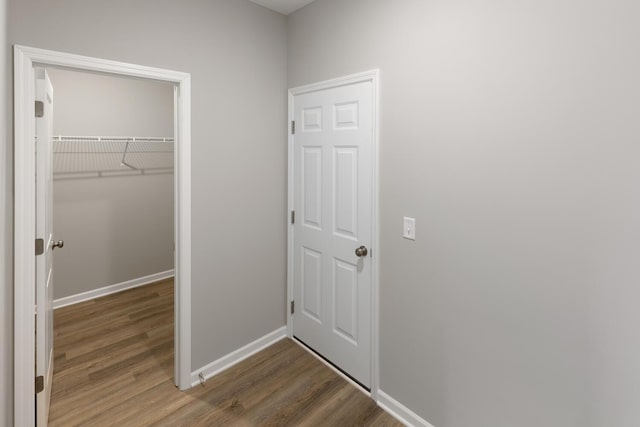 7861 Ramsey Pkwy NW, Ramsey, MN 55303 - unfurnished bedroom with wood finished floors, a closet, and a walk in closet