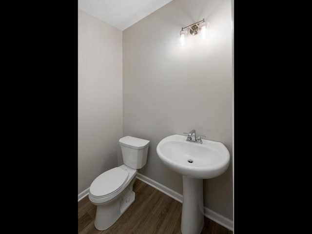 7855 Ramsey Pkwy NW, Ramsey, MN 55303 - half bathroom with toilet and wood finished floors