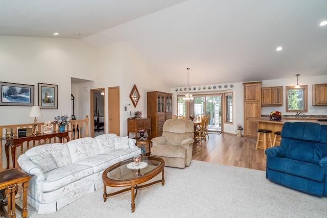 521 Spruce Ln, Crookston, MN 56716 - living room featuring plenty of natural light, a chandelier, light wood-style floors, recessed lighting, and high vaulted ceiling