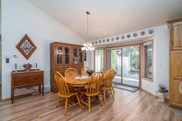 521 Spruce Ln, Crookston, MN 56716 - dining space with a chandelier, light wood-type flooring, and lofted ceiling