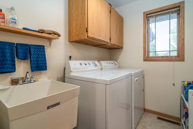 521 Spruce Ln, Crookston, MN 56716 - laundry area featuring cabinet space and separate washer and dryer