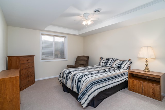 521 Spruce Ln, Crookston, MN 56716 - bedroom with light colored carpet, a tray ceiling, and a ceiling fan