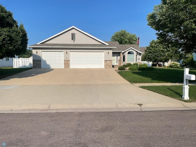 4427 10th St N, Fargo, ND 58102 - ranch-style house with concrete driveway, brick siding, and an attached garage