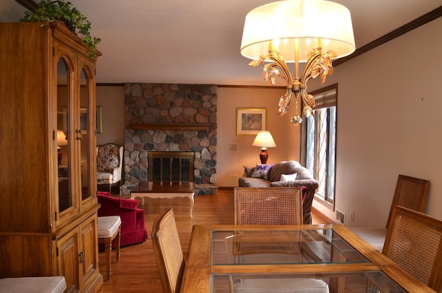 4336 Lookout Ln, Red Wing, MN 55066 - dining room with crown molding, wood finished floors, a fireplace, and a chandelier