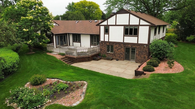 4336 Lookout Ln, Red Wing, MN 55066 - rear view of house featuring a patio, a wooden deck, a lawn, stucco siding, and french doors