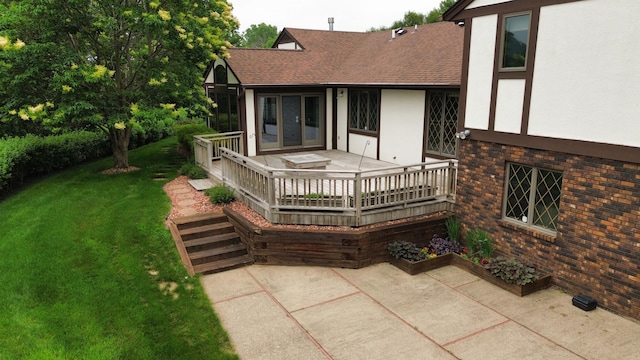 4336 Lookout Ln, Red Wing, MN 55066 - back of property featuring brick siding, stucco siding, a lawn, roof with shingles, and a patio