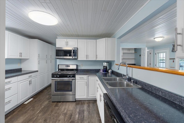 773 US Highway 63, Clayton, WI 54004 - kitchen with appliances with stainless steel finishes, dark countertops, wooden ceiling, and white cabinetry