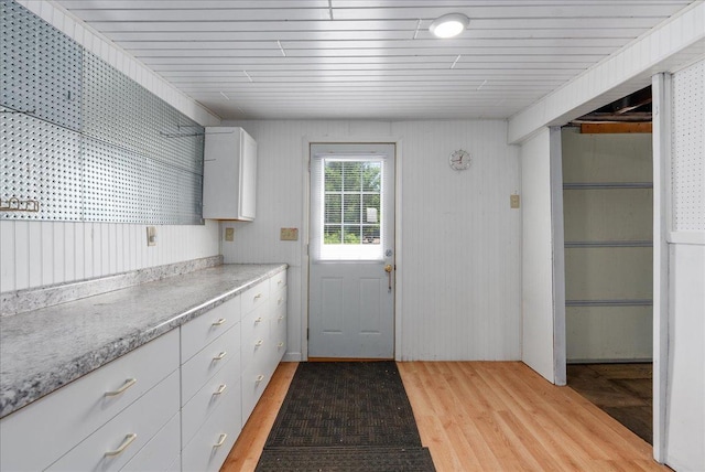 773 US Highway 63, Clayton, WI 54004 - kitchen with light wood-style floors, light countertops, and white cabinetry