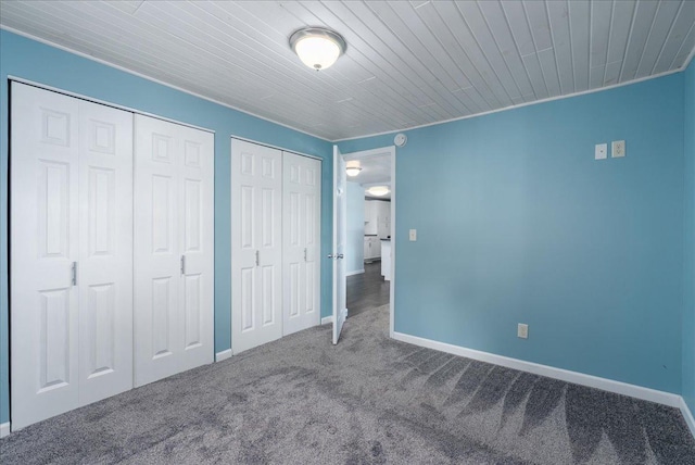 773 US Highway 63, Clayton, WI 54004 - unfurnished bedroom featuring two closets, carpet, and wood ceiling