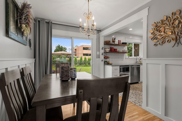 771 Creek Ave, Mendota Heights, MN 55120 - dining room with a chandelier, light wood-style flooring, and wainscoting
