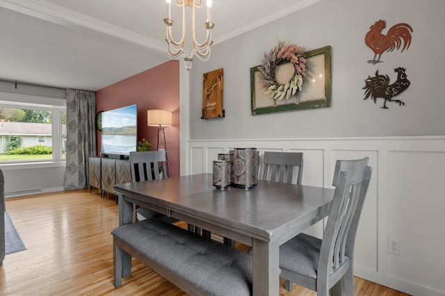 771 Creek Ave, Mendota Heights, MN 55120 - dining space featuring a chandelier, light wood-style flooring, a decorative wall, crown molding, and a wainscoted wall
