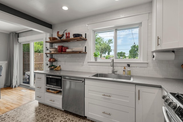 771 Creek Ave, Mendota Heights, MN 55120 - kitchen featuring appliances with stainless steel finishes, tasteful backsplash, white cabinetry, light tile patterned floors, and recessed lighting