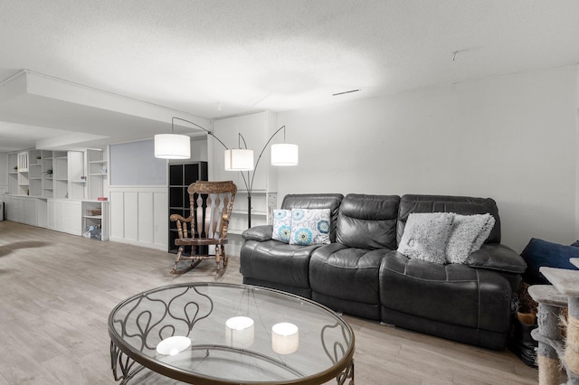 771 Creek Ave, Mendota Heights, MN 55120 - living area featuring wood finished floors, a textured ceiling, and wainscoting