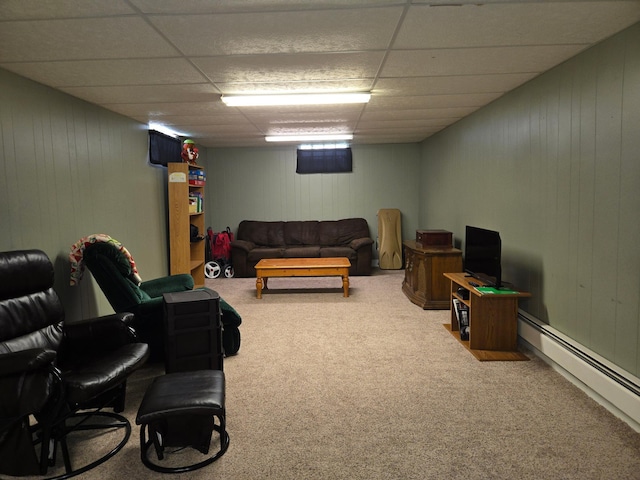 266 6th St, Hancock, MN 56244 - home theater room with carpet floors, wooden walls, a paneled ceiling, and a baseboard heating unit