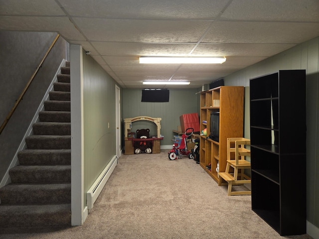266 6th St, Hancock, MN 56244 - finished below grade area with a baseboard radiator, carpet, stairway, and a drop ceiling