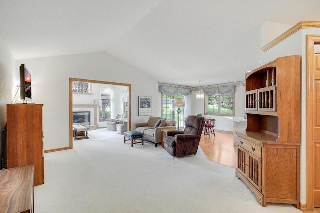 6105 Creekview Ln N, Brooklyn Park, MN 55443 - living area featuring lofted ceiling, a tiled fireplace, and light carpet