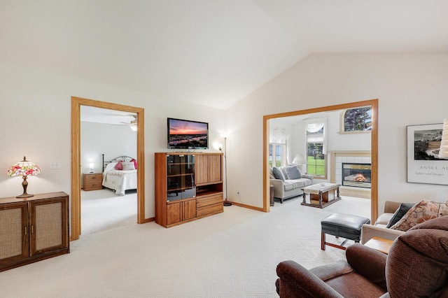 6105 Creekview Ln N, Brooklyn Park, MN 55443 - living area featuring light colored carpet, vaulted ceiling, a ceiling fan, and a tile fireplace
