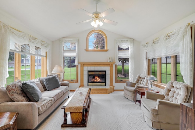 6105 Creekview Ln N, Brooklyn Park, MN 55443 - living area featuring a tiled fireplace, a ceiling fan, vaulted ceiling, and light carpet