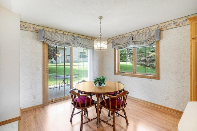 6105 Creekview Ln N, Brooklyn Park, MN 55443 - dining area with light wood-type flooring and wallpapered walls