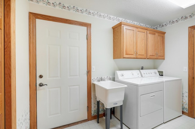 6105 Creekview Ln N, Brooklyn Park, MN 55443 - laundry room with washer and dryer, cabinet space, light flooring, and a textured ceiling