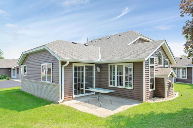 6105 Creekview Ln N, Brooklyn Park, MN 55443 - back of property with roof with shingles, a patio, a yard, and brick siding