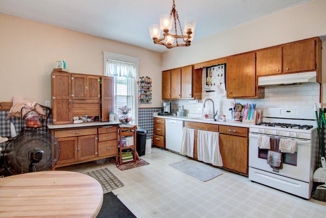 735 Broadway Ave, Wabasha, MN 55981 - kitchen with white appliances, under cabinet range hood, brown cabinetry, a chandelier, and light floors