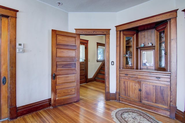 735 Broadway Ave, Wabasha, MN 55981 - corridor featuring light wood-type flooring and crown molding