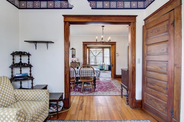 735 Broadway Ave, Wabasha, MN 55981 - foyer entrance with light wood-type flooring, a chandelier, and crown molding