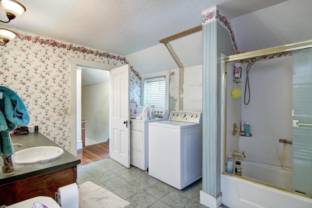 735 Broadway Ave, Wabasha, MN 55981 - full bathroom featuring independent washer and dryer, vaulted ceiling, vanity, a textured ceiling, and  shower combination