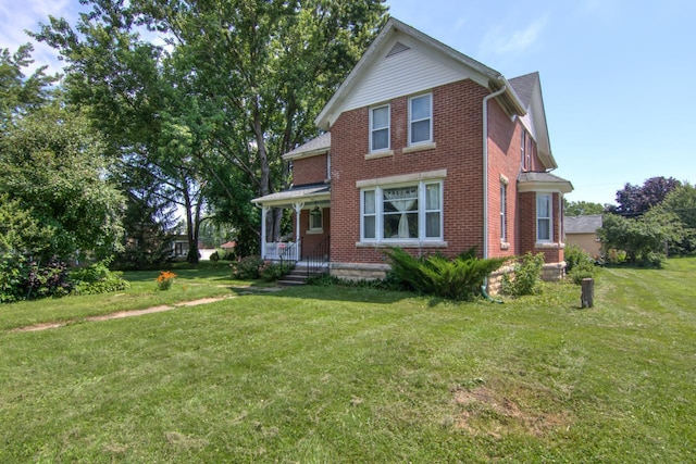 735 Broadway Ave, Wabasha, MN 55981 - view of front of property with brick siding, a front yard, and a porch