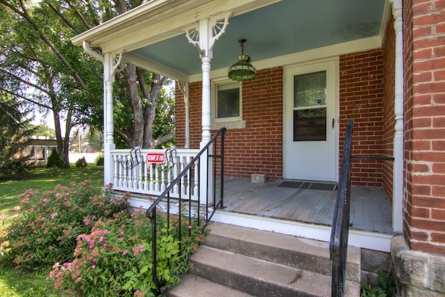 735 Broadway Ave, Wabasha, MN 55981 - doorway to property featuring covered porch and brick siding