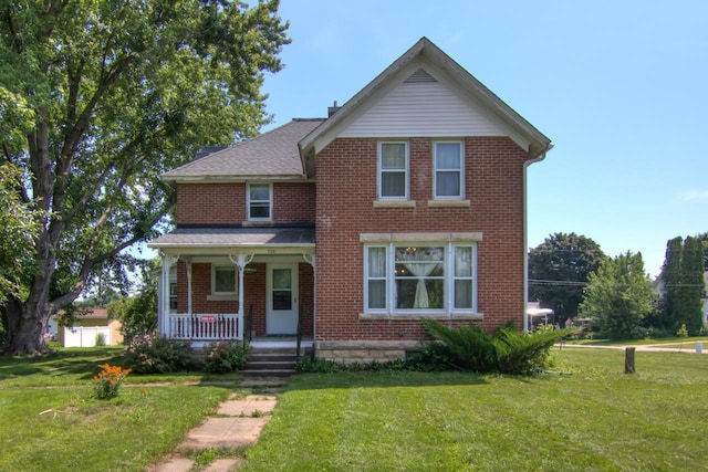 735 Broadway Ave, Wabasha, MN 55981 - view of front of property featuring covered porch, brick siding, and a front yard